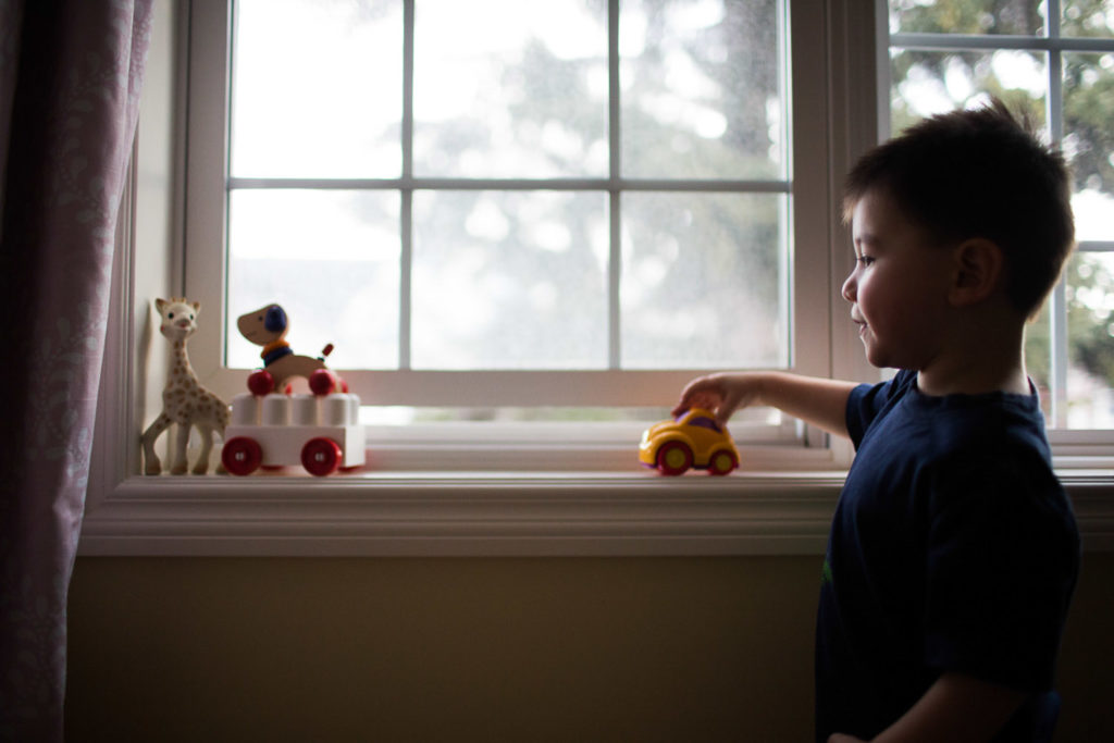 Little boy playing in window