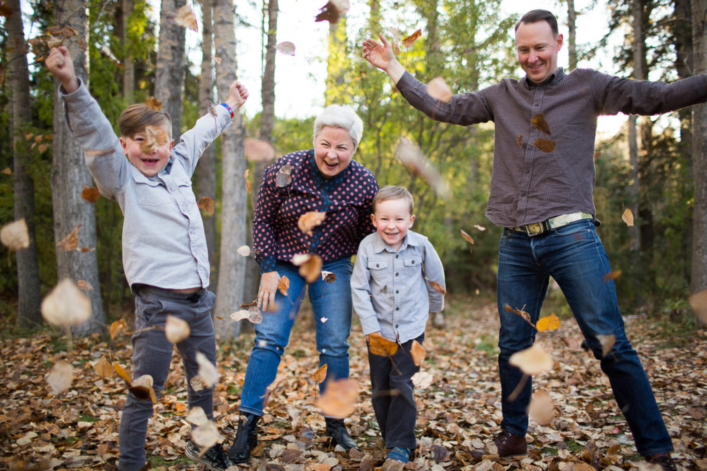 Family throwing leaves in Family Photography session