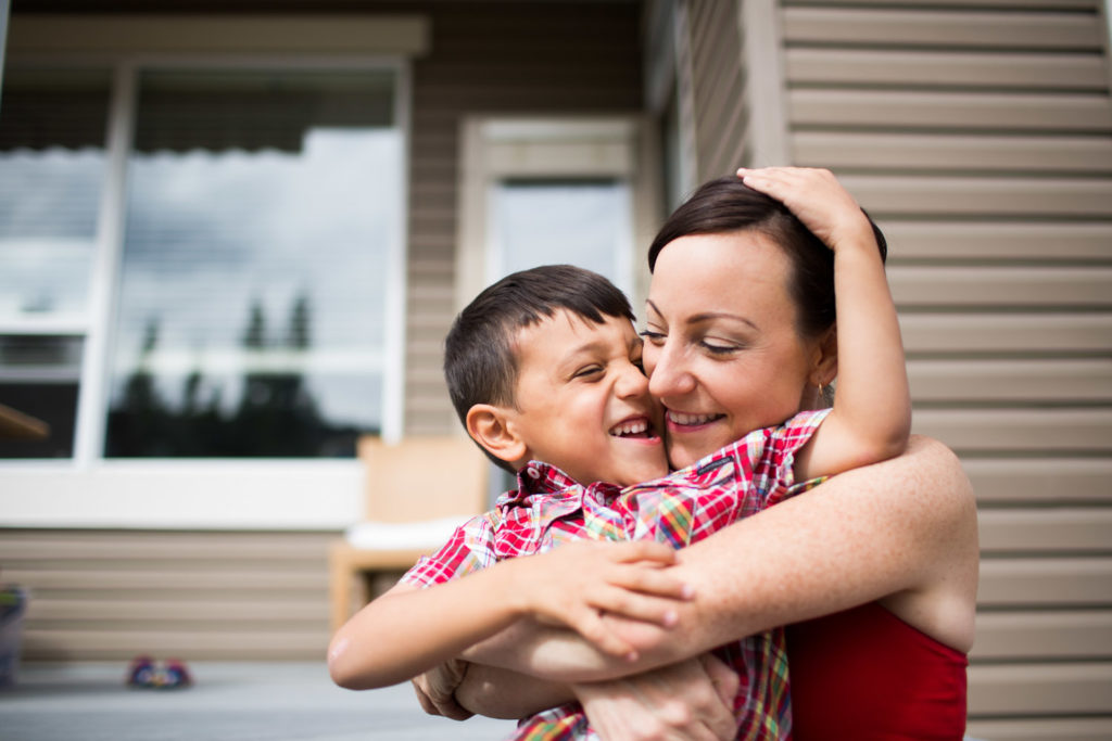 Mom and son hugging in photoshoot